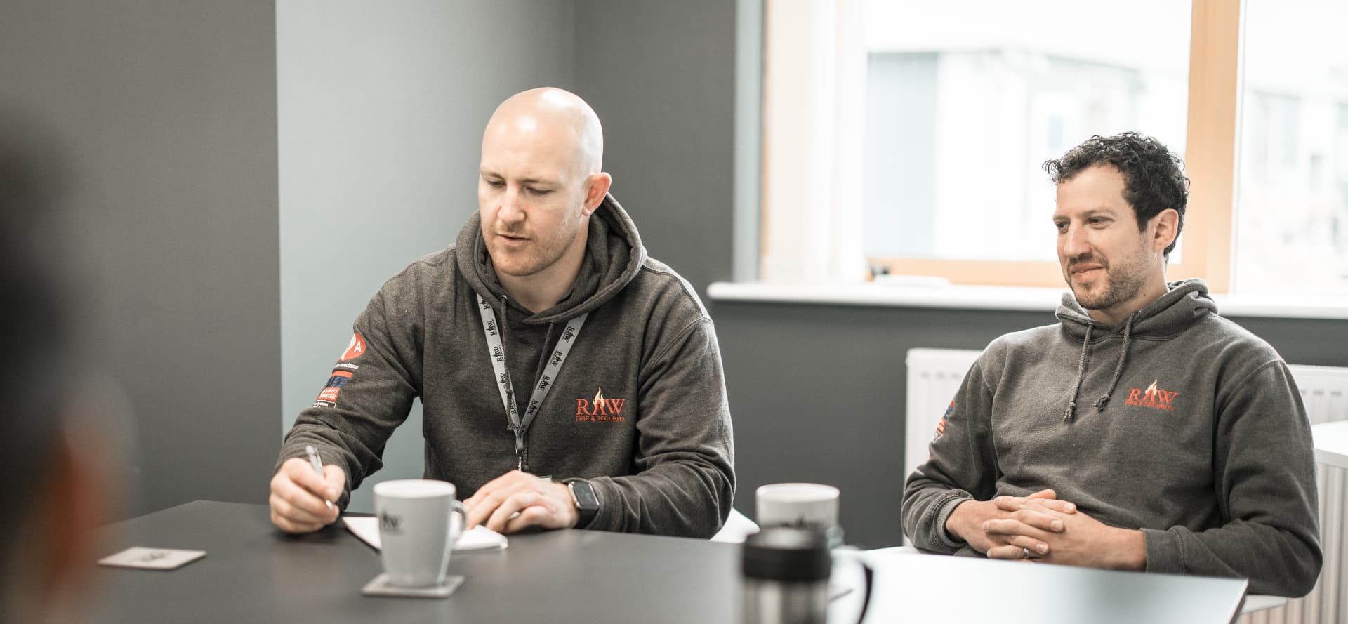 RAW engineers talking through a project with a client in a meeting room