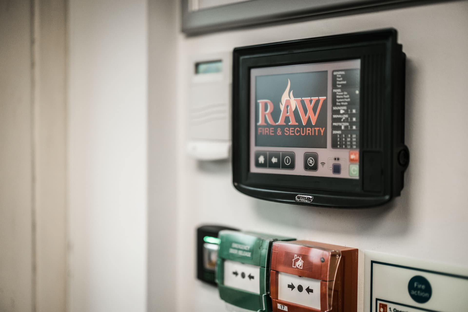 RAW-branded fire alarm control panel with manual call points on a commercial premises